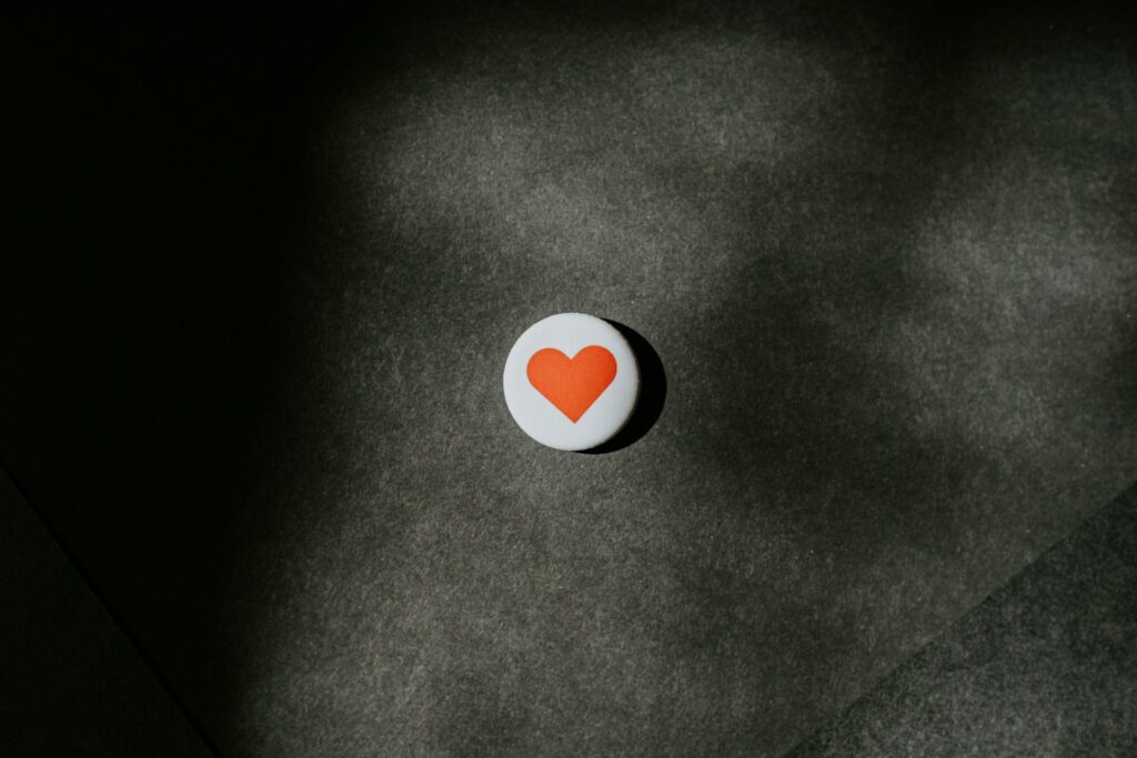 Round white and red heart button